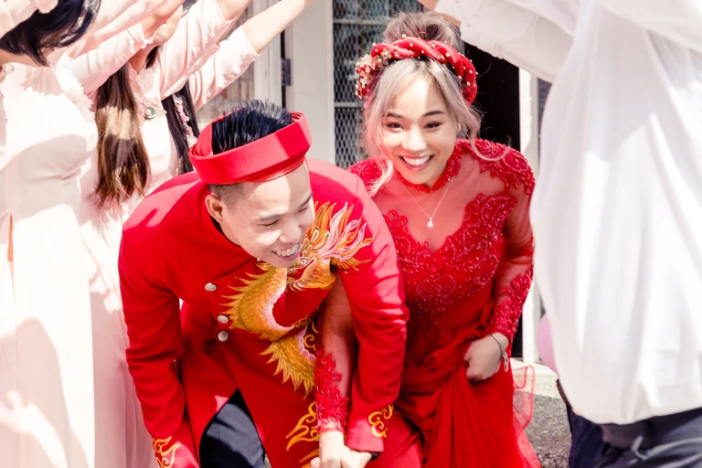 Newlyweds celebrating in traditional wedding attire