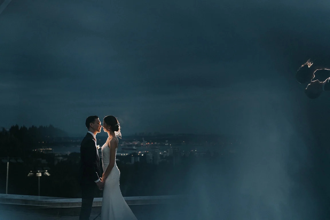 Newlyweds embracing in soft evening light