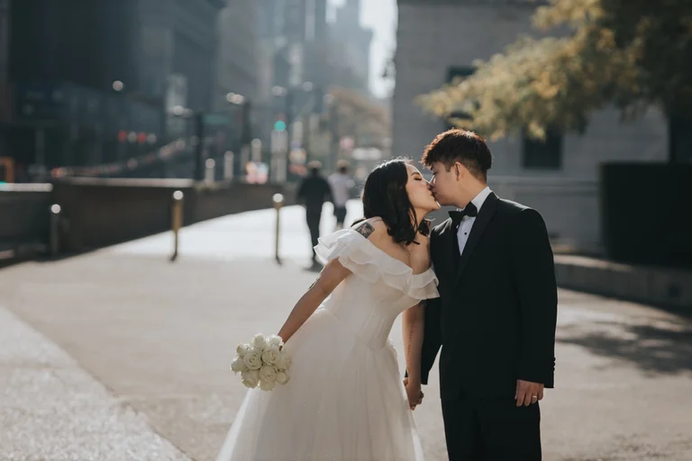Newlyweds embracing on a city street