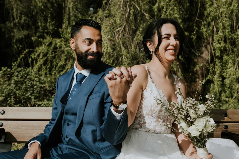 Newlyweds holding hands outdoors