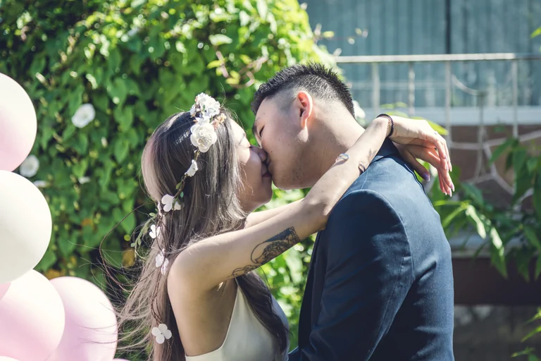 Newlyweds kissing during an outdoor ceremony