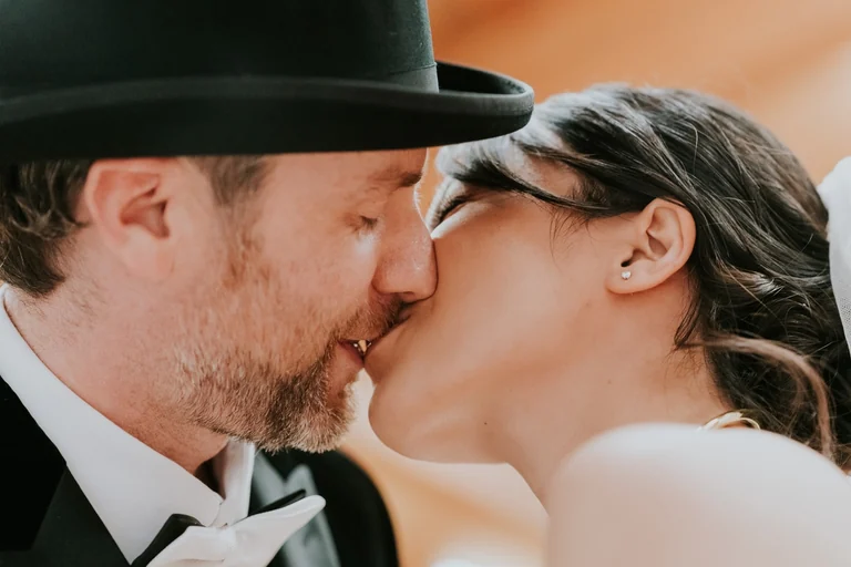 Newlyweds kissing during outdoor wedding portraits