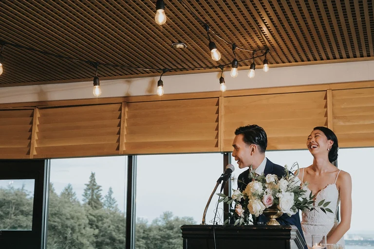 Newlyweds speaking at their reception
