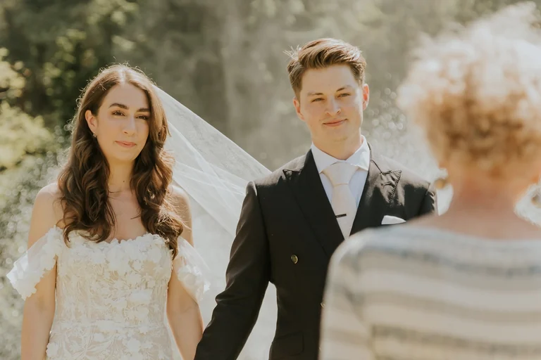 Wedding couple posing near a stone wall