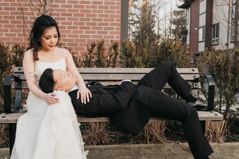 Wedding couple sitting together on stone steps