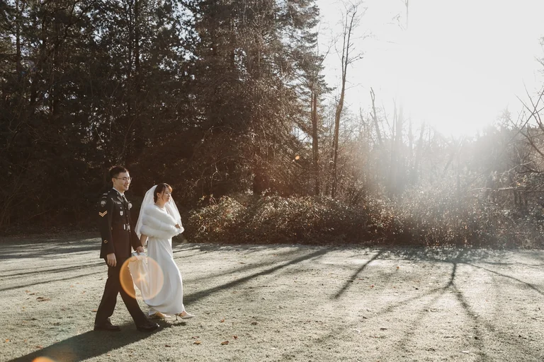 Wedding couple walking through warm afternoon light