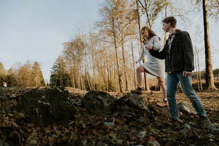 Wedding couple walking together through a wooded landscape