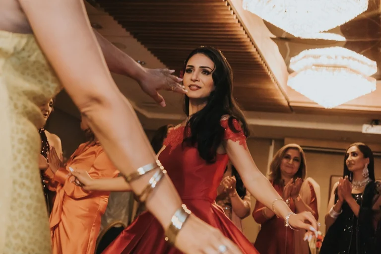Wedding guest dancing in a red dress