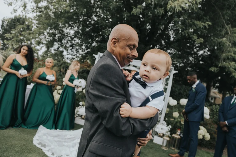 Wedding guest holding a young child