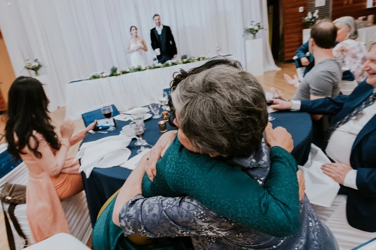 Wedding guests applauding at the reception