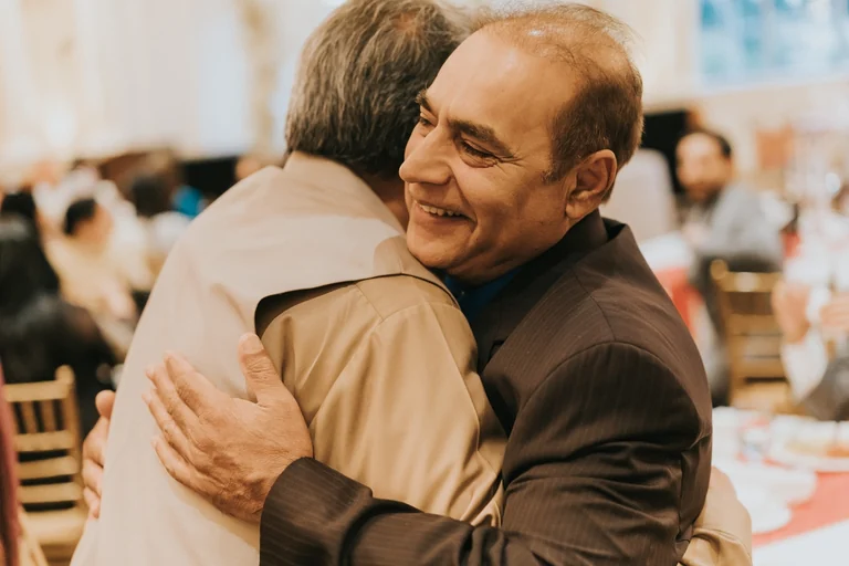 Wedding guests embracing during the reception