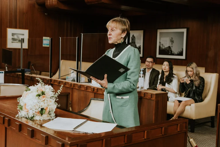 Wedding officiant addressing guests from a lectern