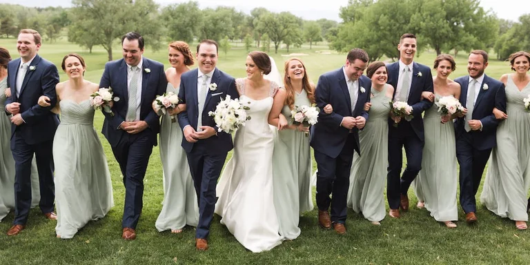 Wedding party celebrating together on a lawn