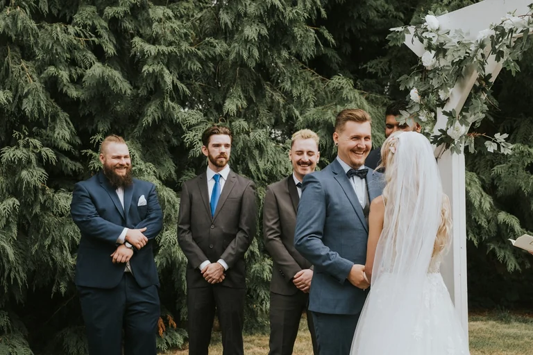 Wedding party gathered beside the bride and groom