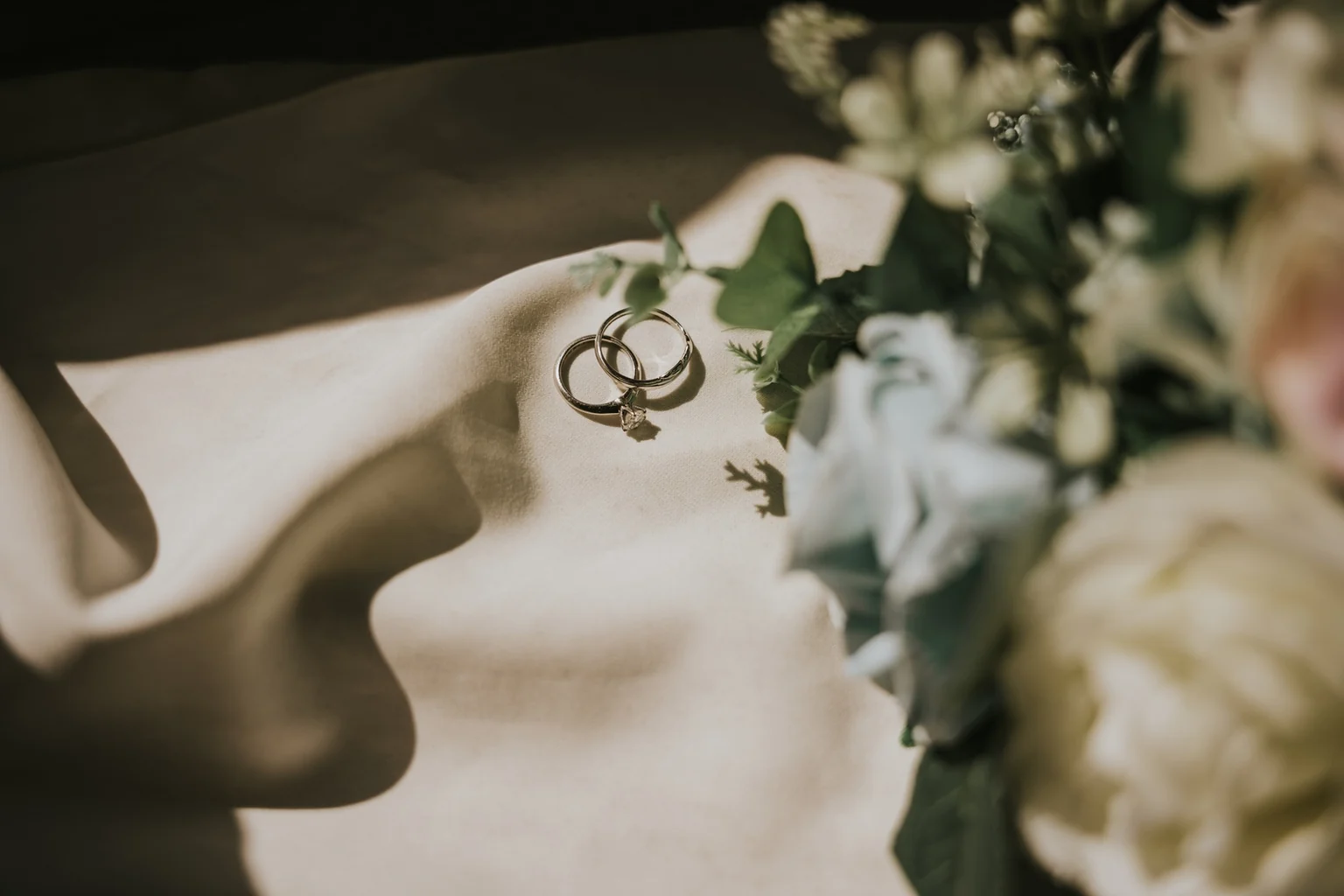 Wedding rings hanging from a flowering branch