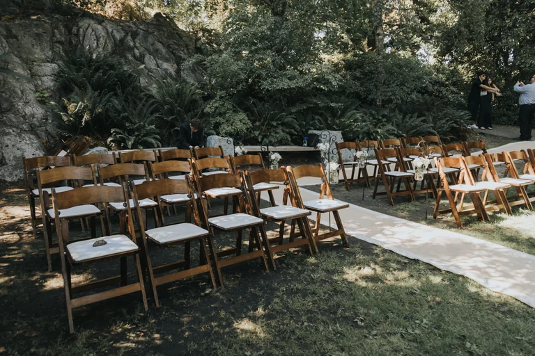 Woodland wedding ceremony chairs and floral arch
