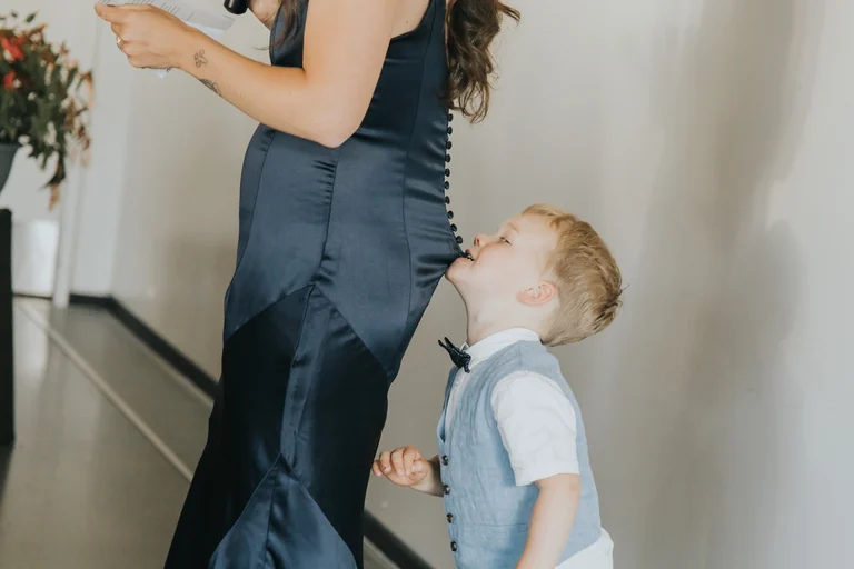 Young child looking up at a wedding guest